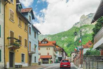 small red car on the road through mountains road trip