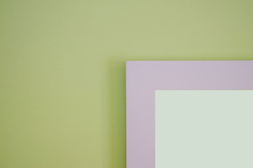 The picture frame is a light green cement wall with a blurred pattern background.