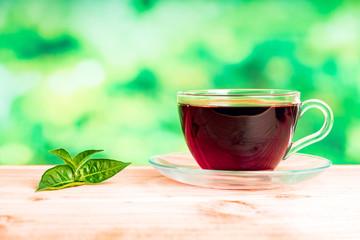 glass of tea on green background