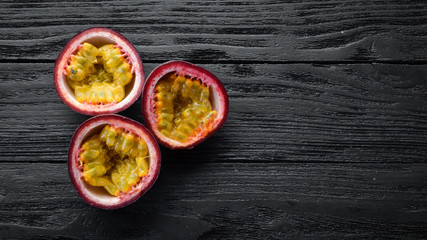 Passion fruits on a wooden background. Tropical Fruits. Top view. Free space for text.