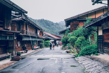 Obraz premium KISO VALLEY, JAPAN - June 10, 2018:Kiso valley is the old town or Japanese traditional wooden houses for the travelers walking at historic old street in Narai-juku , Nagano Prefecture, JAPAN.