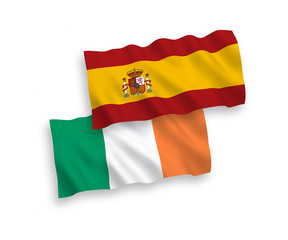 National vector fabric wave flags of Ireland and Spain isolated on white background. 1 to 2 proportion.
