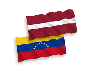 Fototapeta premium National vector fabric wave flags of Latvia and Venezuela isolated on white background. 1 to 2 proportion.