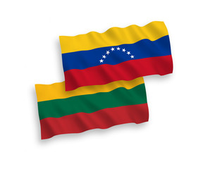 National vector fabric wave flags of Lithuania and Venezuela isolated on white background. 1 to 2 proportion.