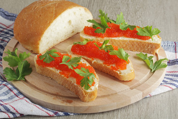 Sandwiches with butter and red caviar
