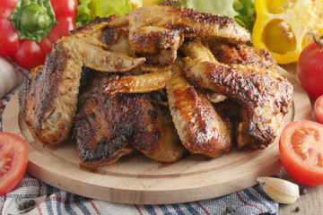 Chicken wings barbecue with different vegetables	