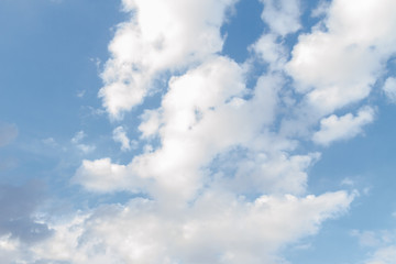 White fluffy clouds in the blue sky in summer