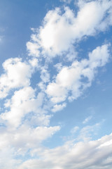 White fluffy clouds in the blue sky in summer