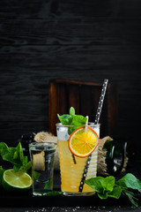 Orange mint cocktail in a glass.