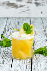 Yellow tropical drink cocktail in a glass. Passion fruit, lemon, rum.