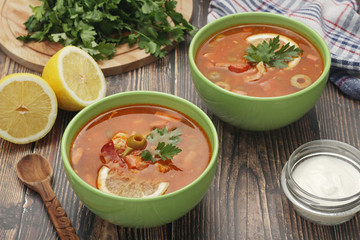 Two bowls with traditional Russian soup solyanka	