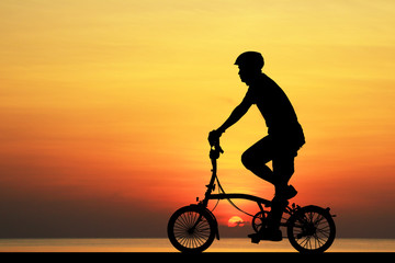 Silhouette  Cycling  on blurry sunrise  sky   background.