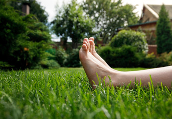 Close up children feet on green grass