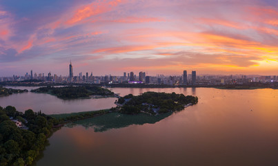 Naklejka premium Beautiful sunset glow over Xuanwu Lake in Nanjing city taken with a drone flying in the air.