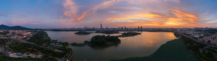 Beautiful sunset glow over Xuanwu Lake in Nanjing city taken with a drone flying in the air.