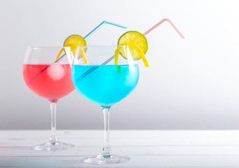 red and blue cocktail in a gin glass on a white background