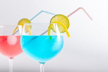 red and blue cocktail in a gin glass on a white background