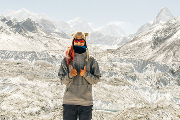 Landscape with girl, high mountains with snowy peaks, path, blue sky in Nepal. Travel. Vintage style. Nature