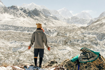 Landscape with girl, high mountains with snowy peaks, path, blue sky in Nepal. Travel. Vintage style. Nature