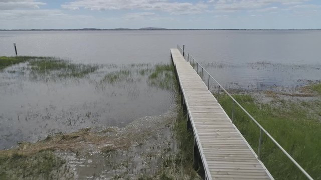 drone over town road and lake
