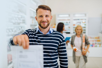 Handsome bearded man holding document in right hand