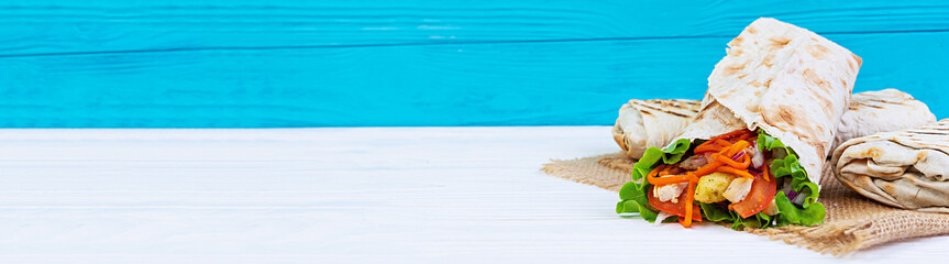 Delicious shawarma sandwich on wooden background. Banner.