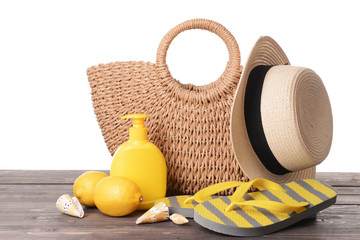Beach accessories on table against white background