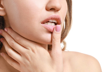 Fototapeta premium Young woman with beautiful lips on white background, closeup