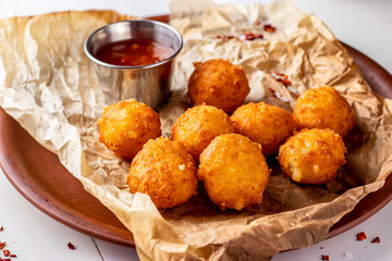 Cheese balls and tomato sauce, beer snack, horizontal photo