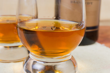 Brandy in cognac bowl close-up in selective focus