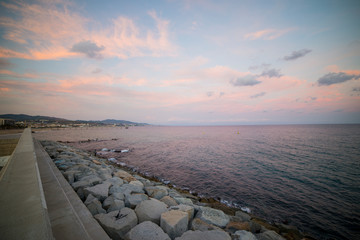 Barceloneta Beach in Barcelona with colorful sky at sunrise