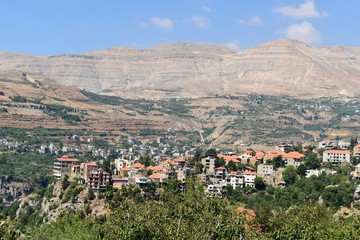 Fototapeta na wymiar overview of the village of Bcharre with houses built at the edge of the cliff of saints valley, mount Lebanon, Lebanon