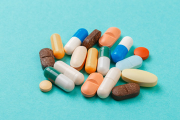 colour tablets and pills on blue background .