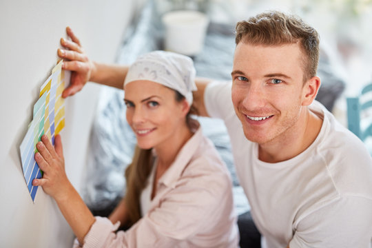 Young couple renovating with color samples