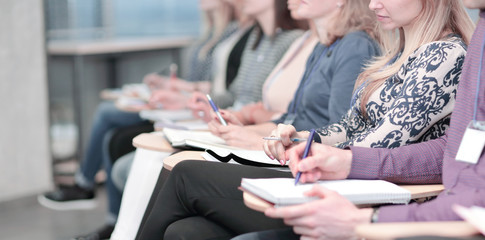 business group taking notes in clipbord sitting in the conference room.