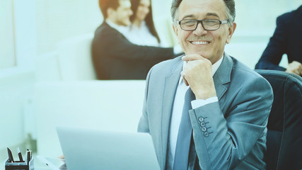 successful businessman on workplace with the laptop