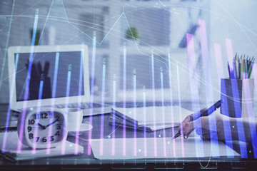 Financial graph displayed on woman's hand taking notes background. Concept of research. Multi exposure