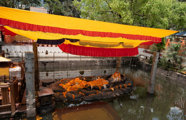 Budhanilkantha statue of the Hindu god Vishnu which lies in a reclining position inside a recessed...