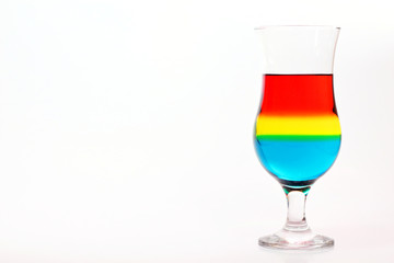 Glass and colored liquids on white background