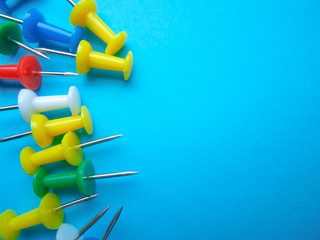 Red, green, yellow, white and blue plastic buttons on a blue background.