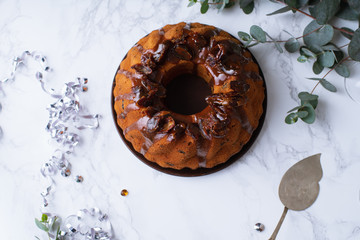 Flatlay with festive bundt cake with dates and salted caramel. Sticky toffee pudding style. Copy space