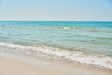 Fototapeta na wymiar View of beach and sea, blue water. Tourism and vacation on ocean. Family vacation in summer. Vacation at sea . Summer travel.