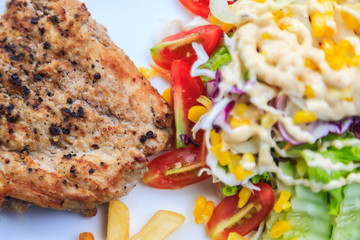 grilled steak with fries and tomato