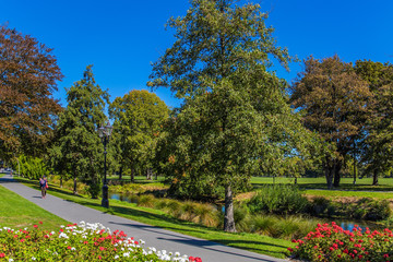 Woman with a red bag walking along the path