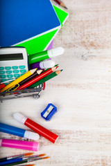 Items for school in a shopping cart.