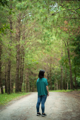 Fototapeta premium young cute Japanese Asian hipster girl travelling at beautiful sky mountains scenery park hiking garden views at Kanchanaburi Thailand guiding idea for female backpacker woman women backpacking