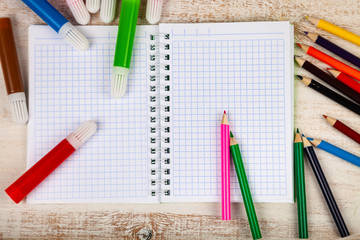 Items for the school on a wooden table.