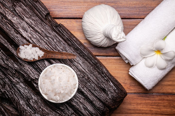 Fototapeta premium Spa aromatic sea salts, and herbal massage ball on wooden background.