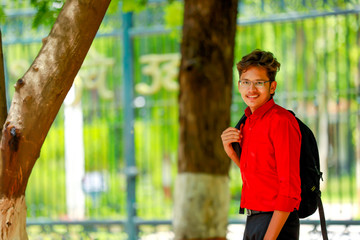 Obraz premium Indian college boy with Holding bag 