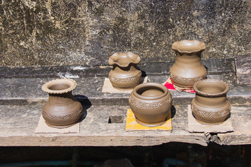 Clay pots made by hand of Thai traditional pottery jar placed in the outdoor to the sun of villages at Ko Kret, Nonthaburi province, Thailand.